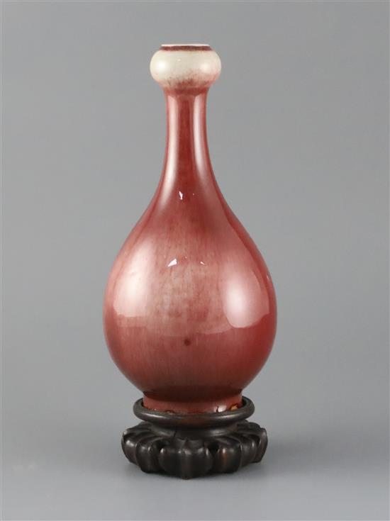 A Chinese sang de boeuf lang yao garlic neck vase, 19th century, H.24cm, two small foot chips, wood stand